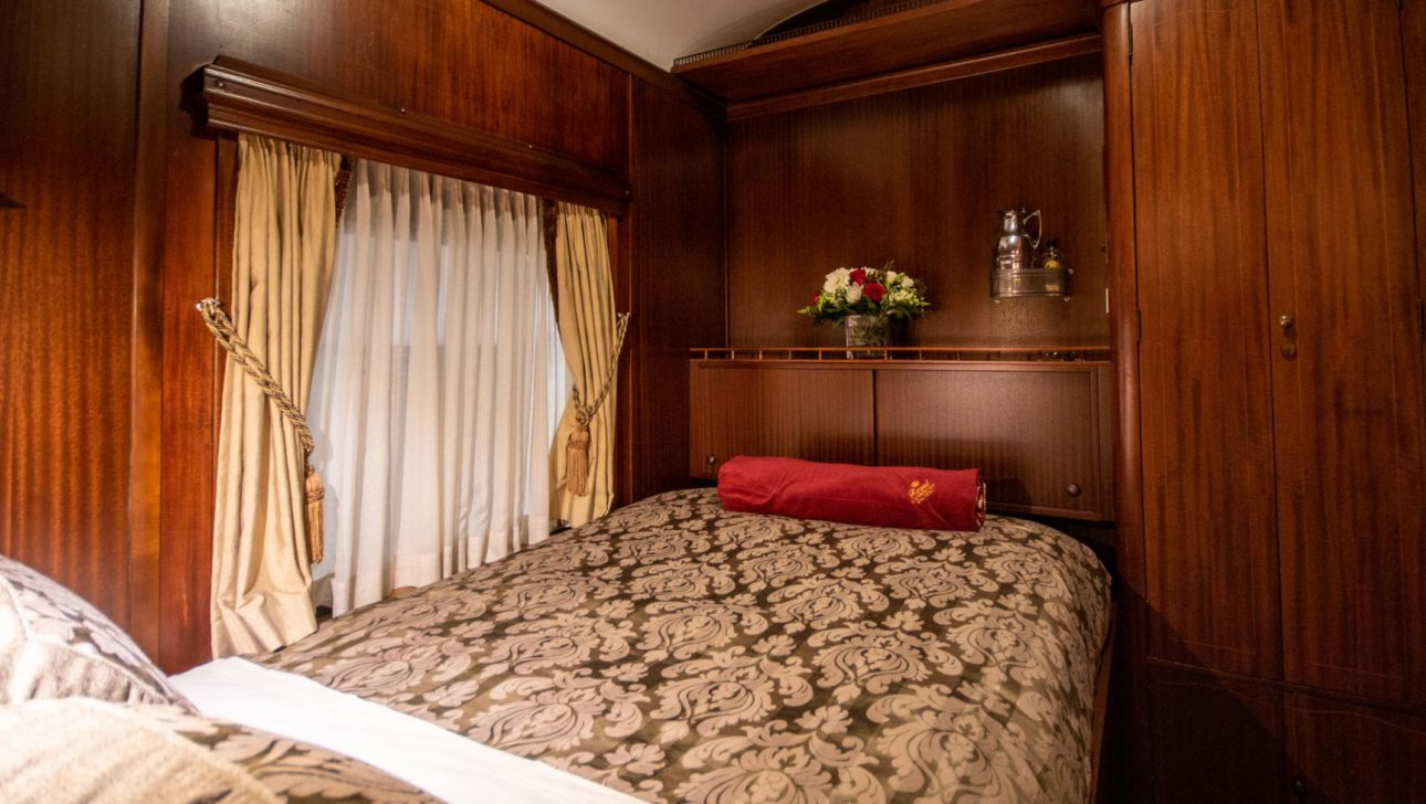 Queen sized bed in a train car.